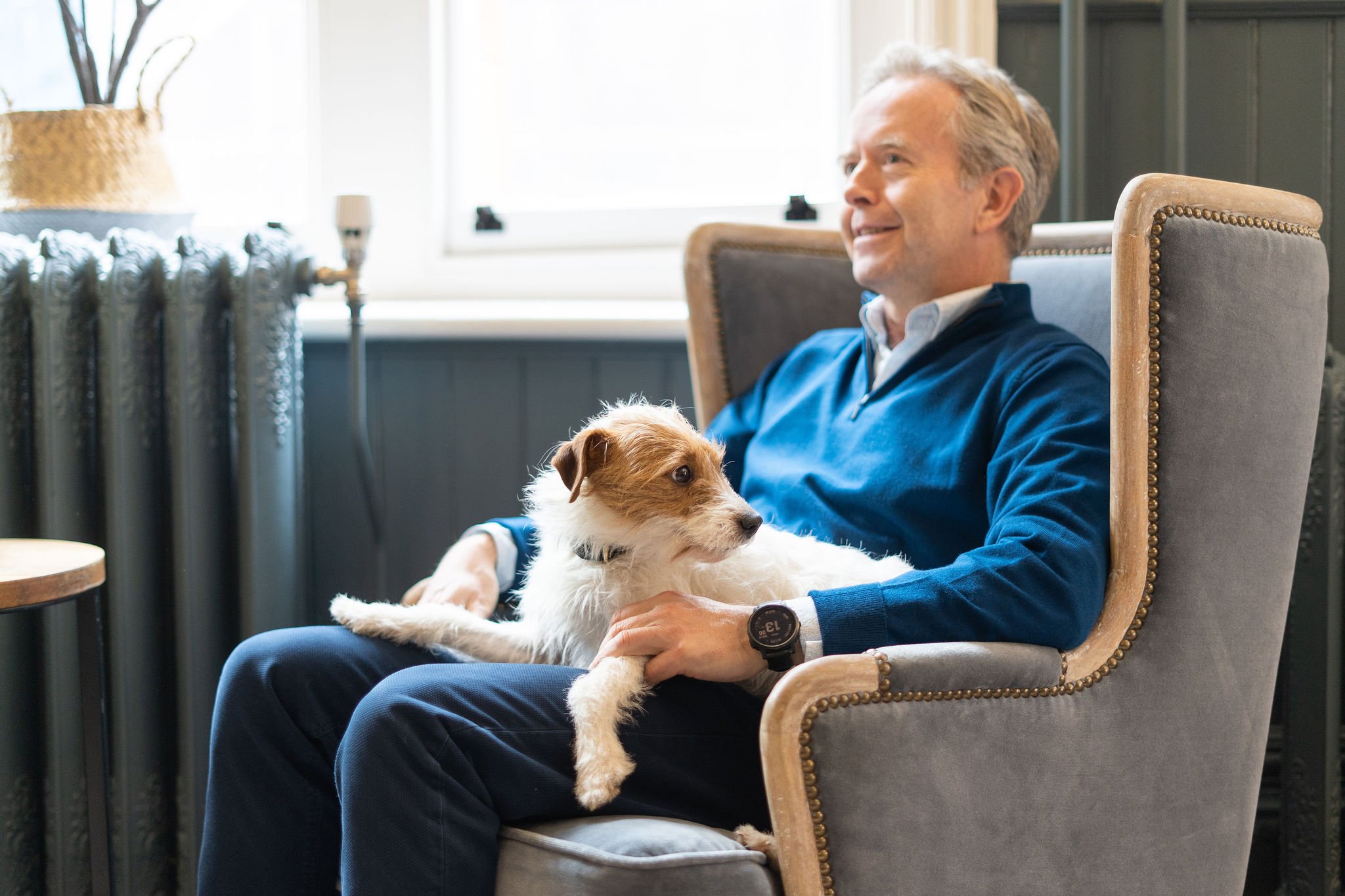 TCN Toby Bidwell Sat On a Chair With a Dog On His Lap