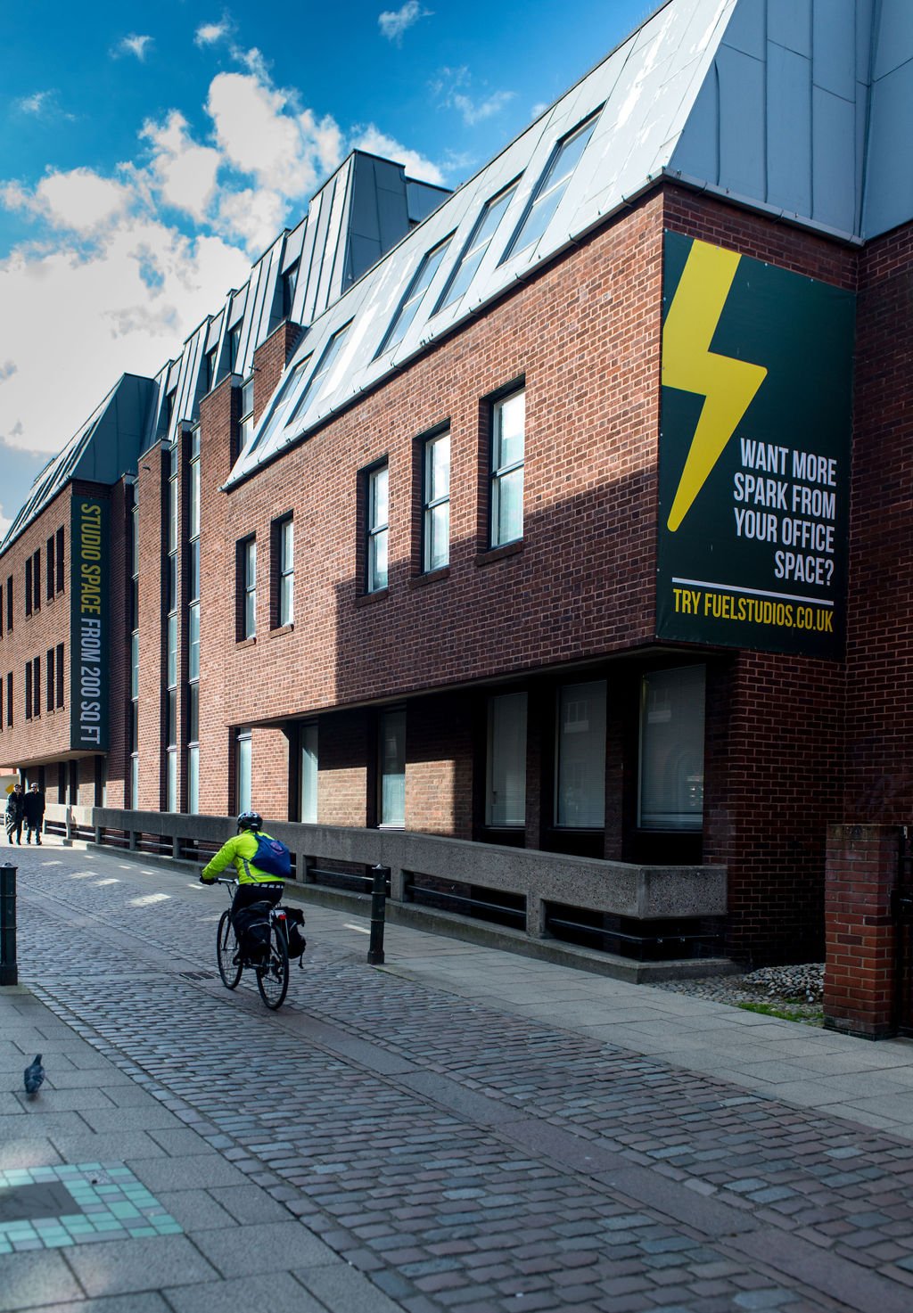 TCN Fuel Studios Norwich Building Exterior with Cyclist Riding Past