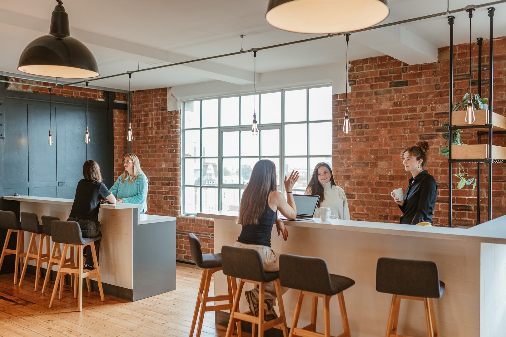 Piano House Unit 5.01 Office space to let, view of private kitchen with people sat chatting