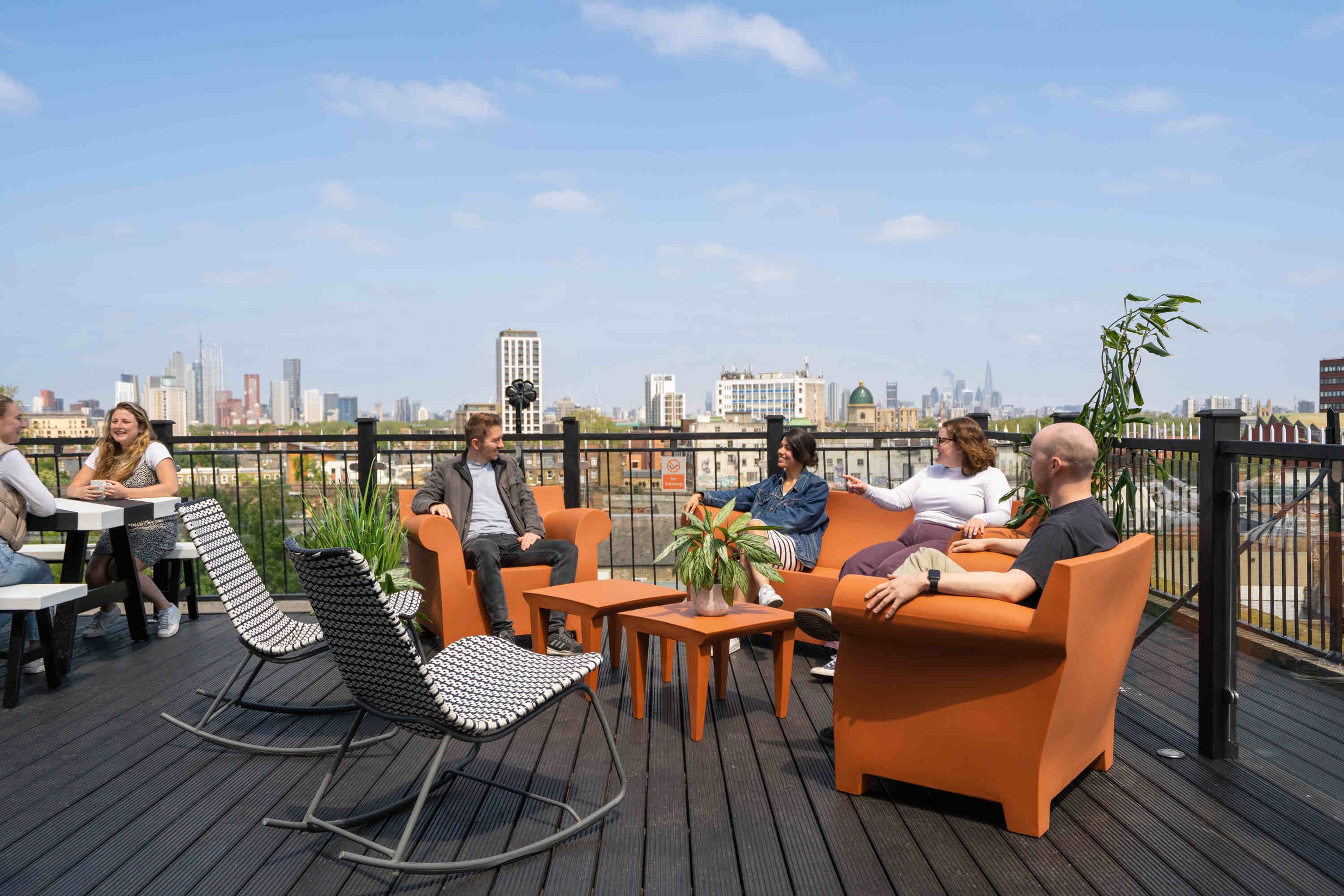 TCN Piano House Brixton Rooftop Terrace With Members Seated On Chairs