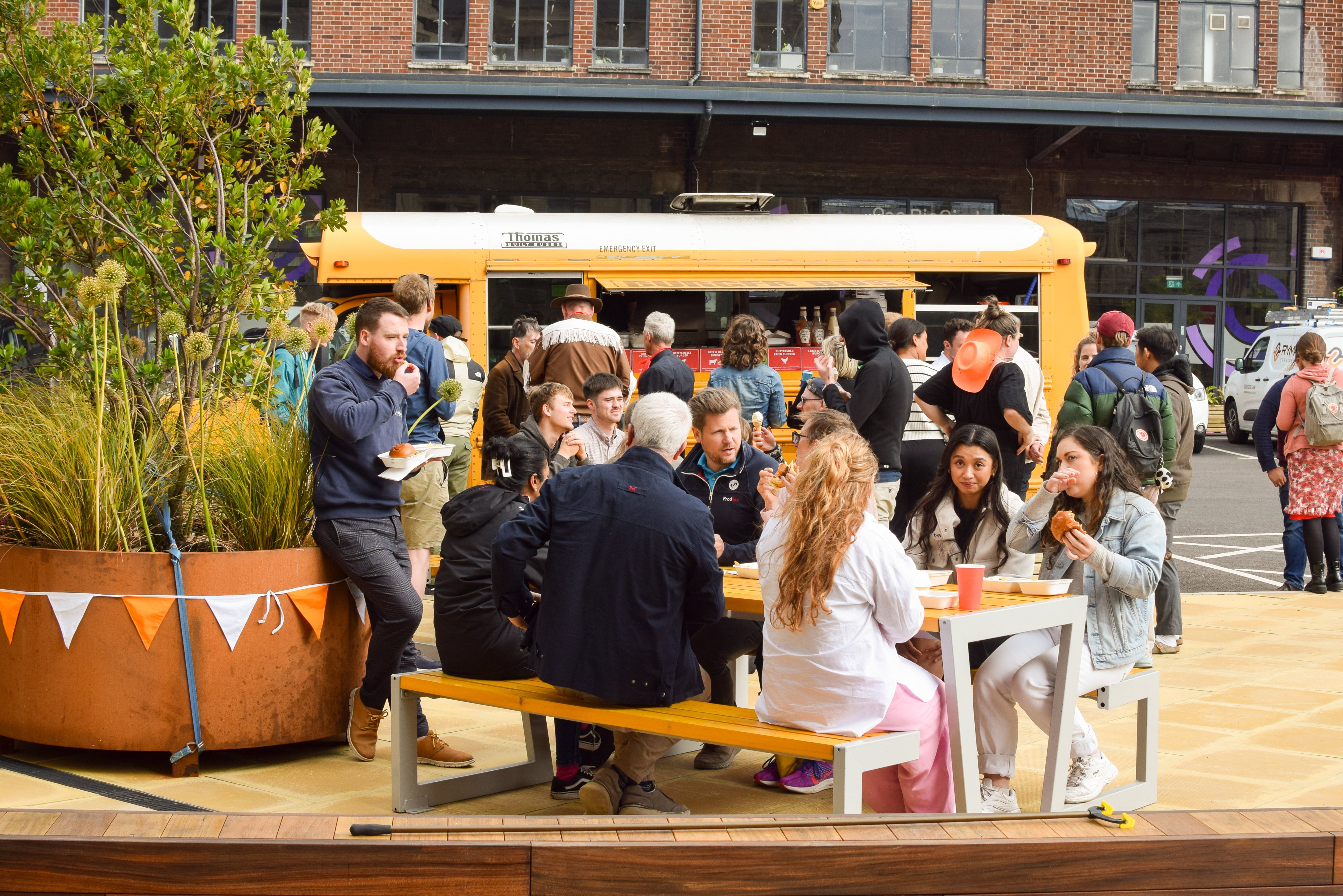People sat outside enjoying the Temple Campus workspace Summer Party